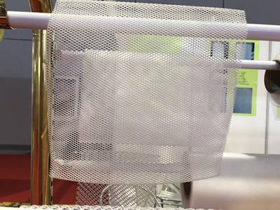 There is a piece of clear extruded feed spacer mesh.