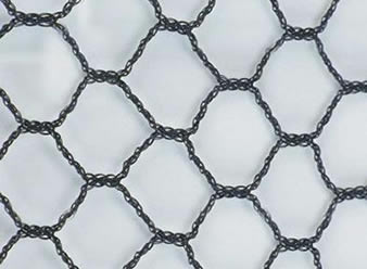 A piece of black hexagonal knitted bird netting on the white background.