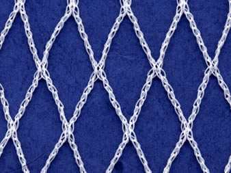 A piece of white knitted garden netting on the blue background.