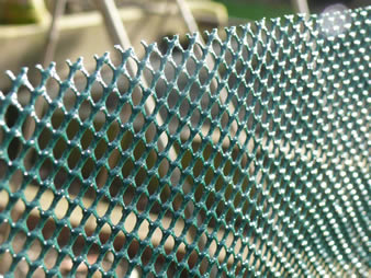 A piece of hexagonal extruded windbreak mesh in the garden.