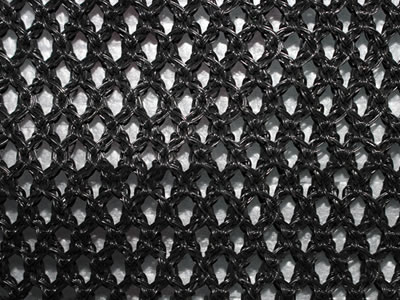 A piece of black color flexible windbreak netting on the table.
