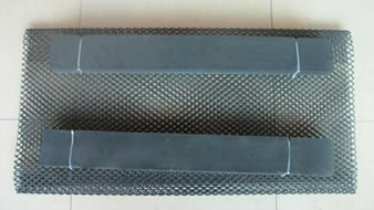 A set of black rectangular foam float oyster mesh bag on the floor.
