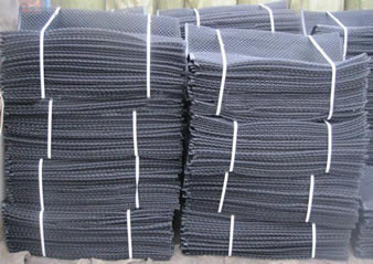 Several bundles of oyster mesh bag on the ground.