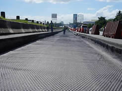The quaxial plastic geogrid is installed on the paved ground.